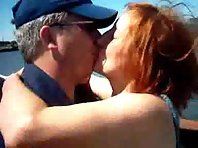A red haired slut fucks two men outdoors